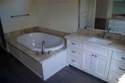 Bathroom's vanity top and a jacuzzi with a marble finish