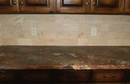 Granite counter top with a tiled backsplash