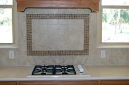 A granite countertop with a custom backsplash.